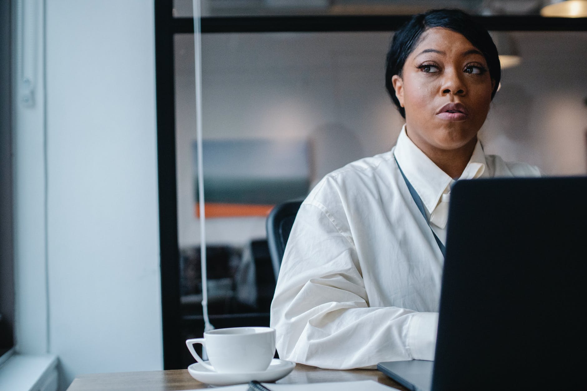 thoughtful black businesswoman working on project in office