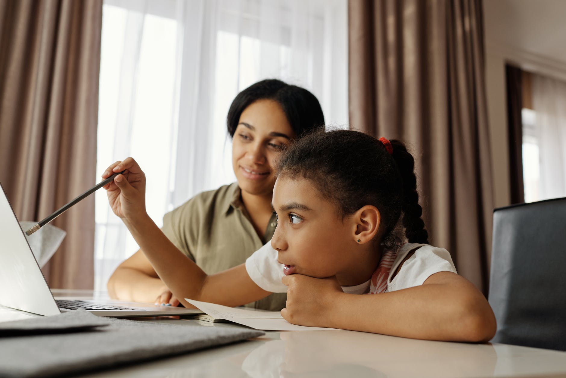 mother helping her daughter with homework